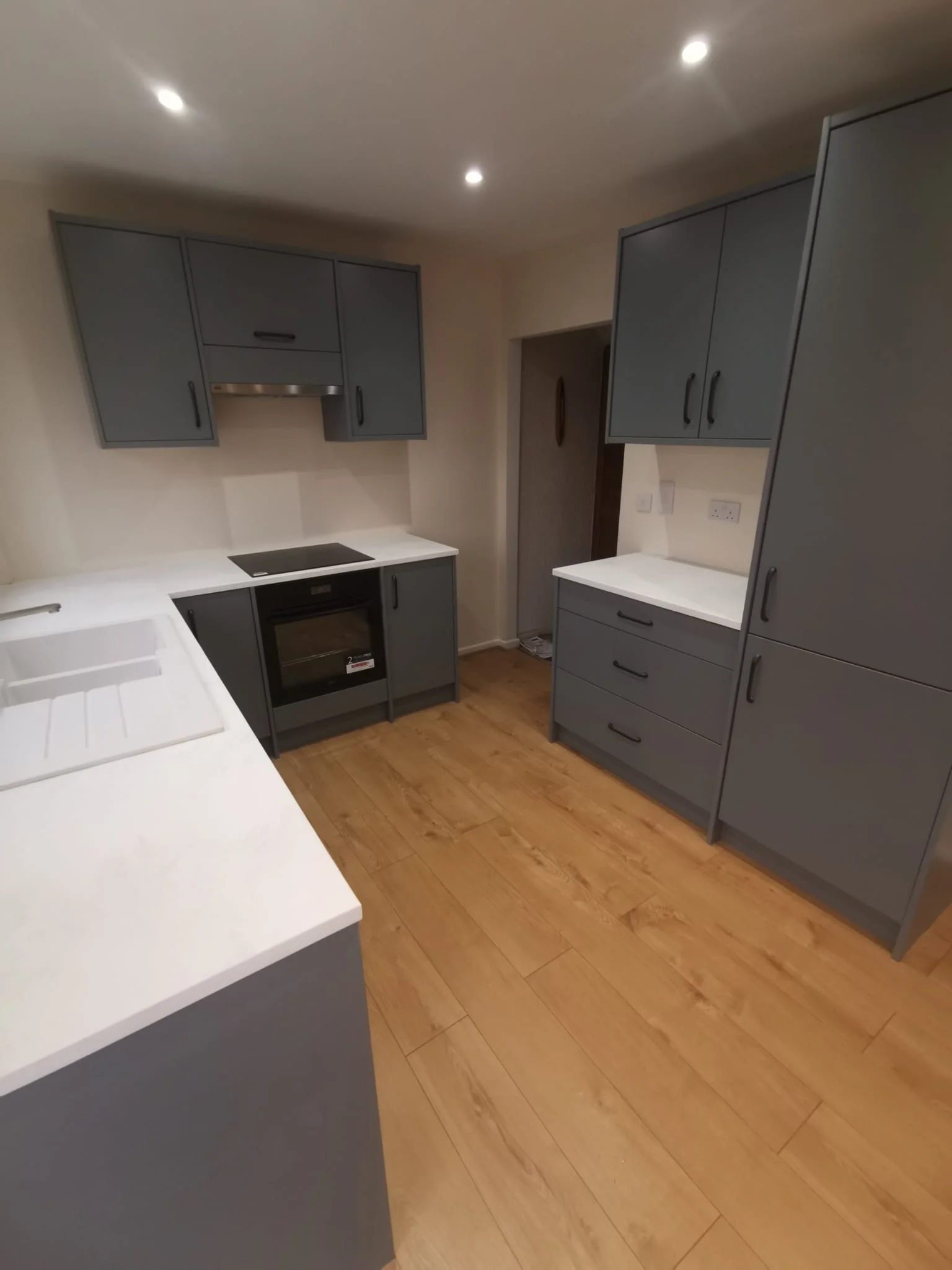 Kitchen cabinetry fitted against newly finished walls